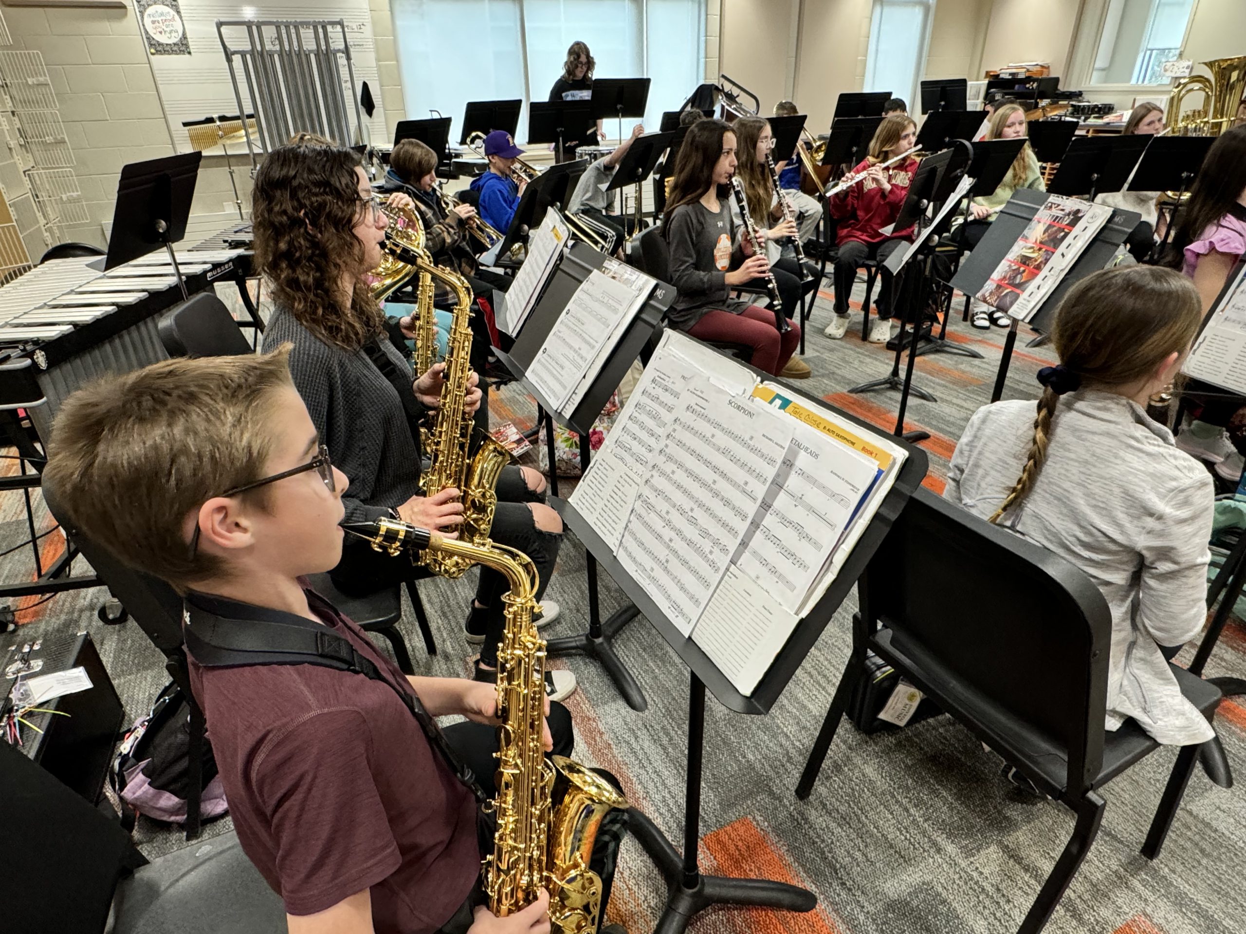 Middle school students playing saxophone in the orchestra