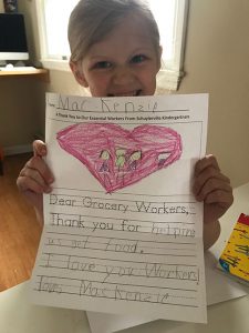 A student with her letter to grocery store workers.