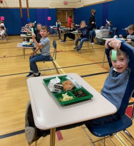 Students with coupons for eating veggies