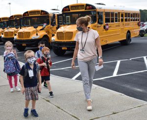 Principal Rose Beckett walks with kindergarten students on the first day of school.