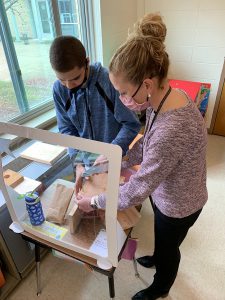 Student works on building birdhouses