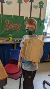 Student with completed bluebird house project