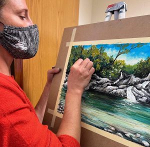 Kendra Farstad works on an oil pastel drawing.