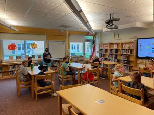 Maria Weeks welcomes students on the first day of school