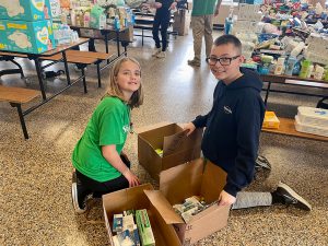 Students help pack boxes.