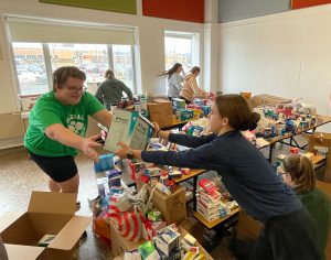 Students assist packing and sorting items for Ukraine.