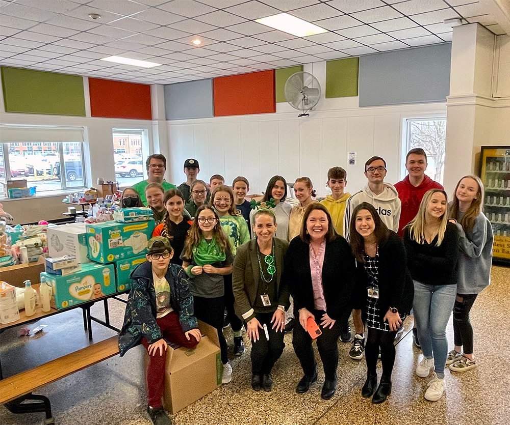 Students and staff help organize and pack donations.