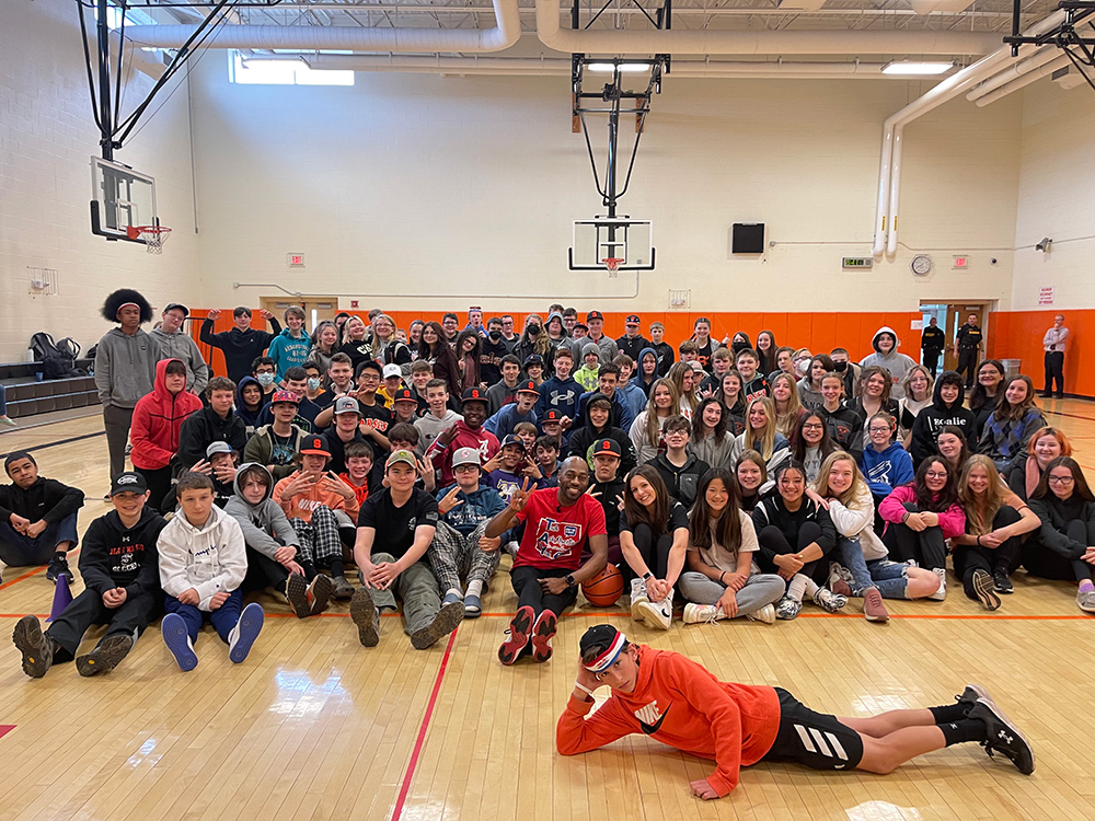 Motivational speaker Tay Fisher with middle school students