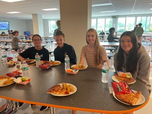 students eat lunch in the cafeteria