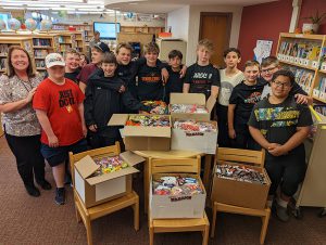 Principal Katie Elsworth with middle school students and the Treats for Troops candy.