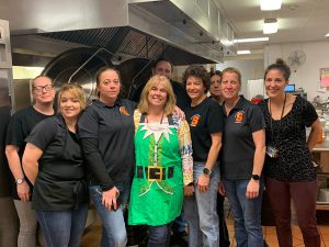 Central office and food service staff serving breakfast.