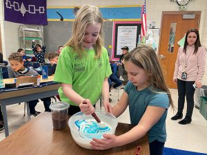 Students build the cake