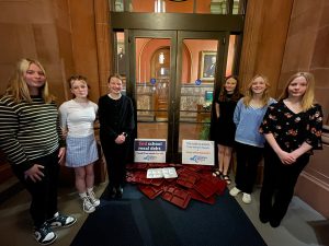 Students deliver empty trays to the door outside the Governor's office