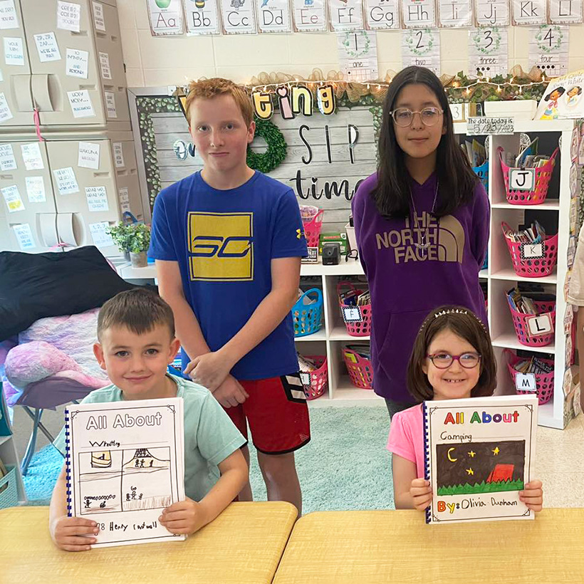 first grade and sixth grade students collaborate