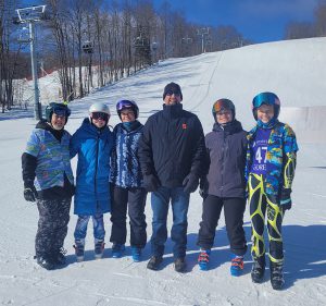 Athletic Director John Bowen with the Schuylerville High School varsity girls ski team