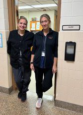 School nurses Robin Englehart and Rebecca Stanislowsky standing in a doorway