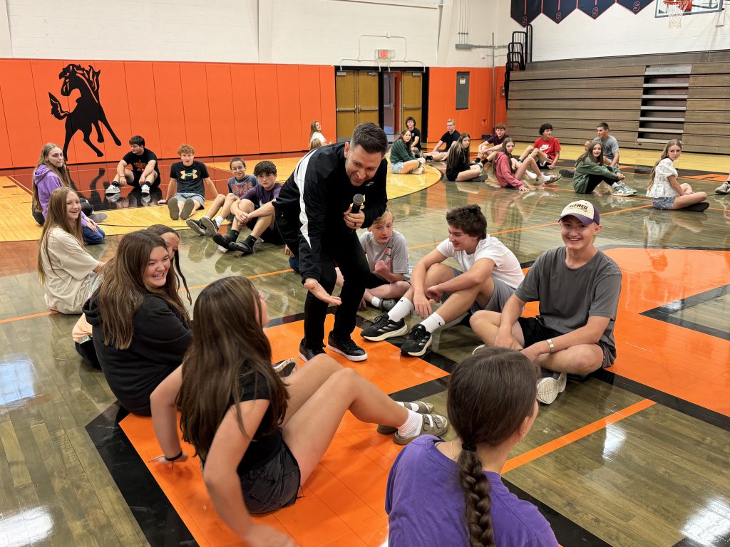 Brandon White speaks with students at the freshman transition event.