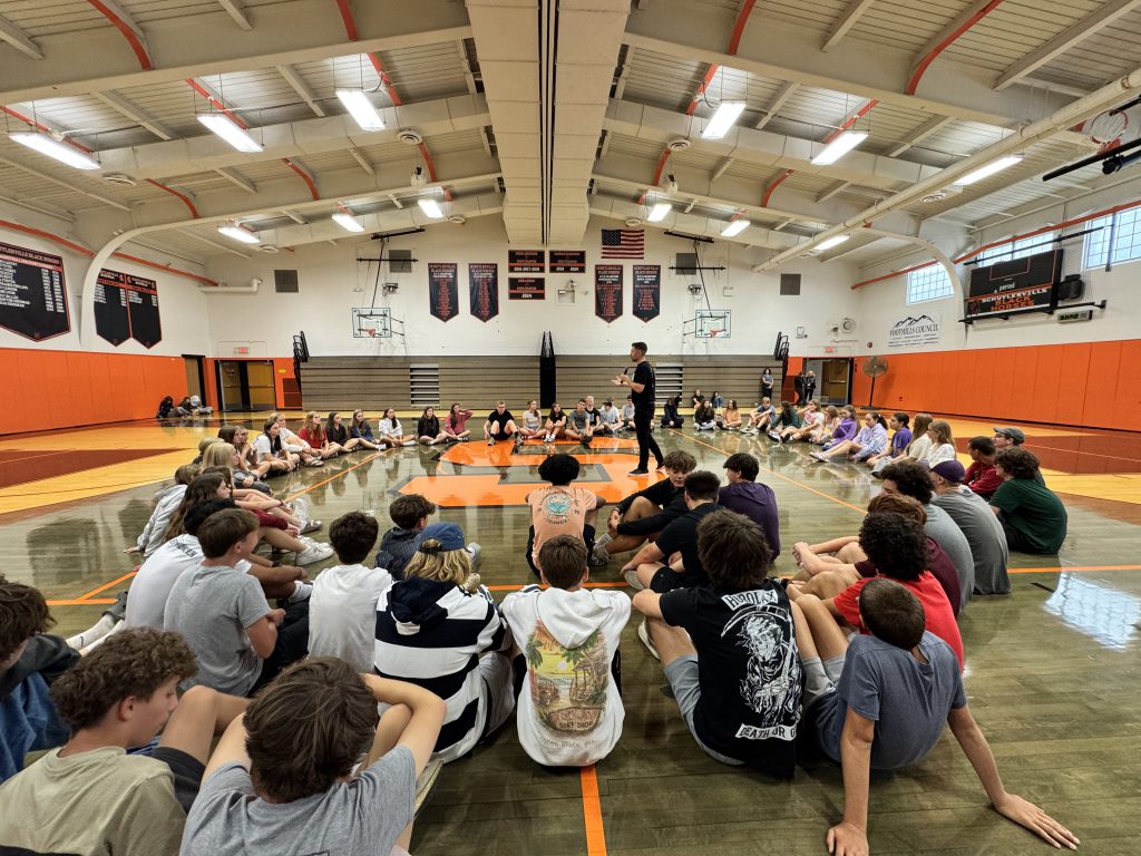 Brandon White works with students during a ballroom dance workshop.
