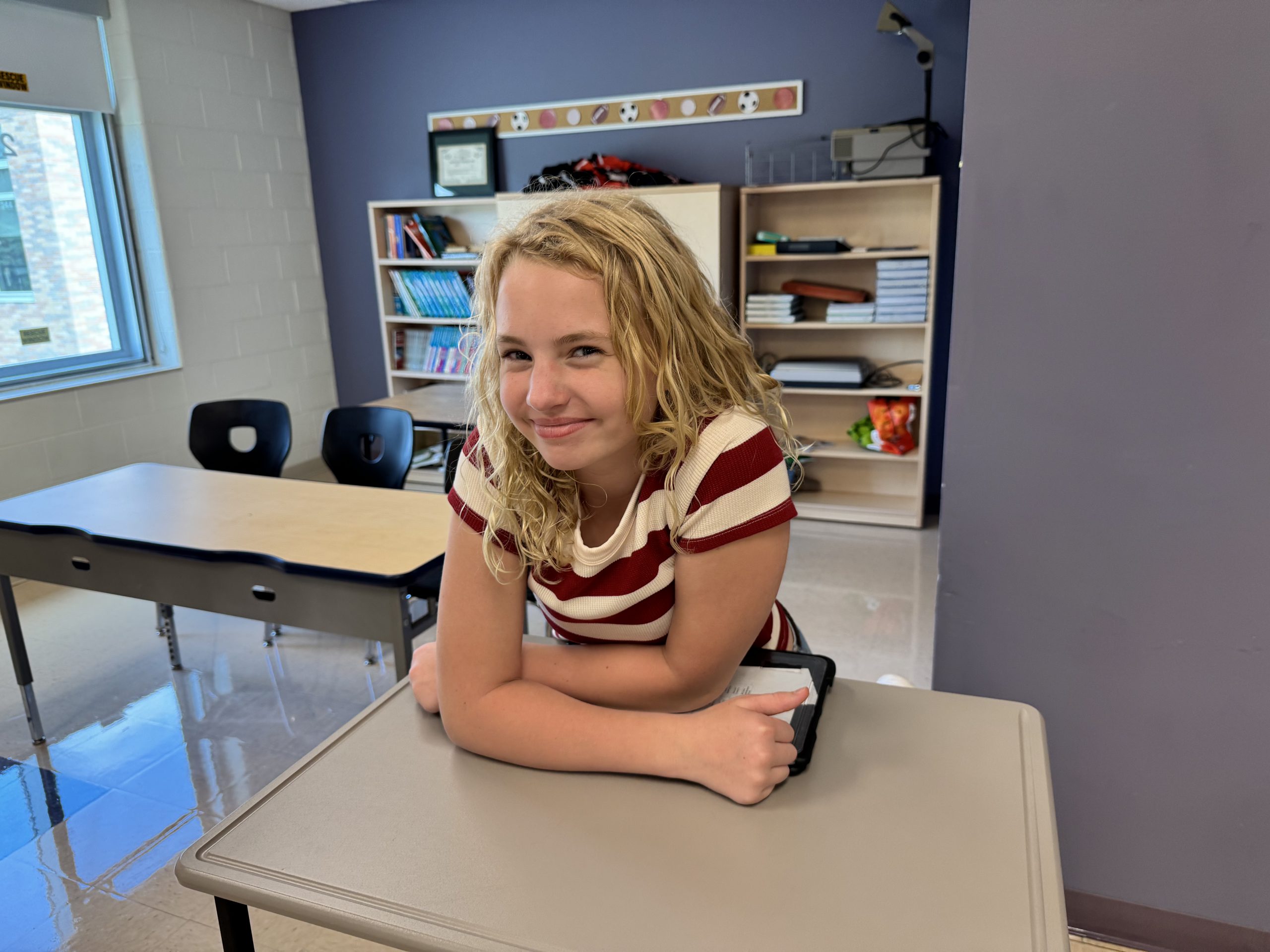 A middle school student smiles on the first day of school