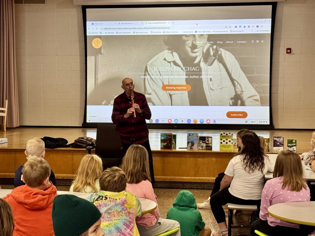 Joseph Bruchac plays his Native American flute for Schuylerville students.