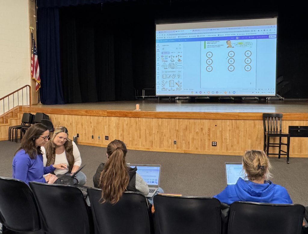 Bry Ludwin supports a colleague during an AI training session.