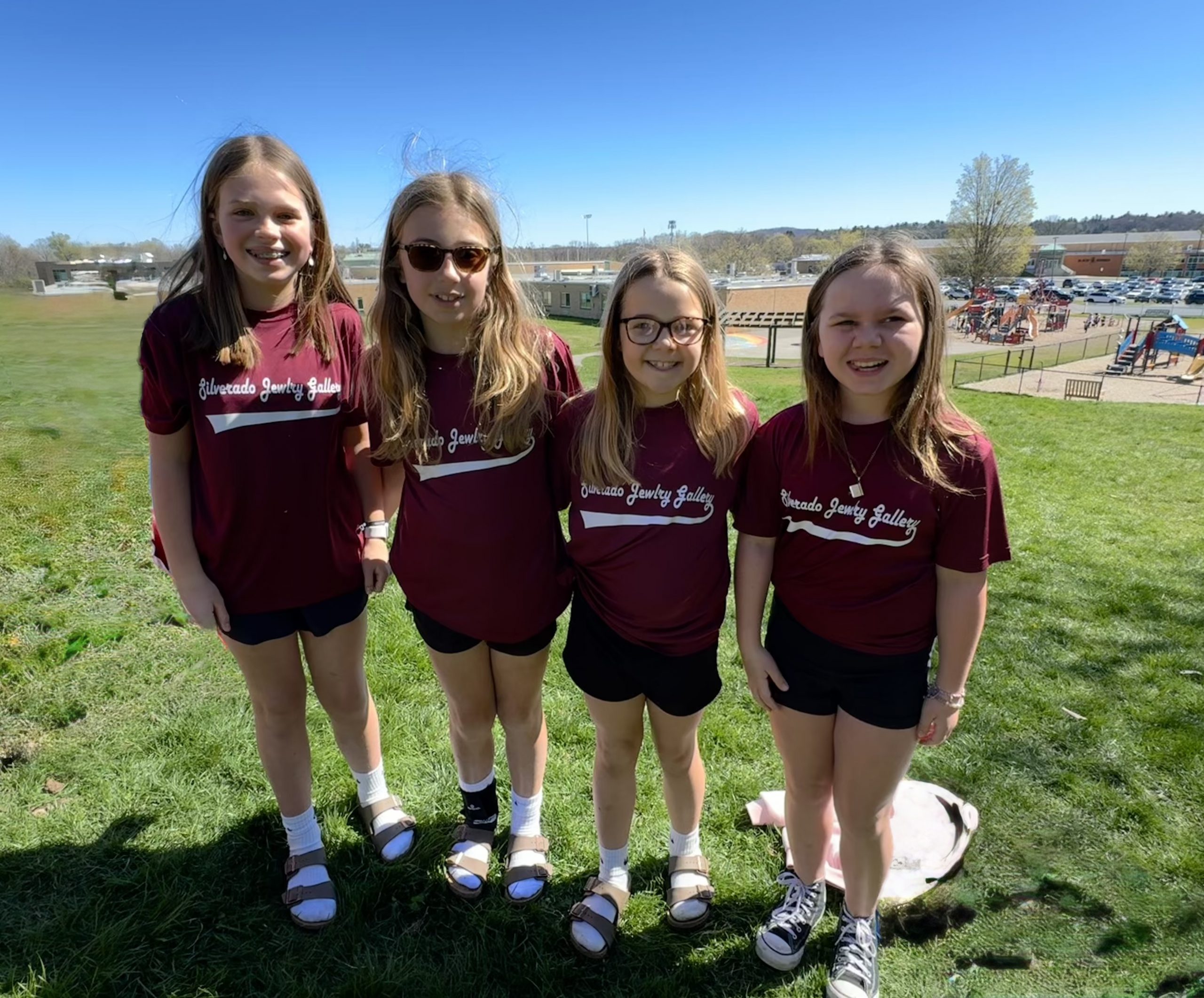 Student wear their softball jerseys to celebrate opening weekend