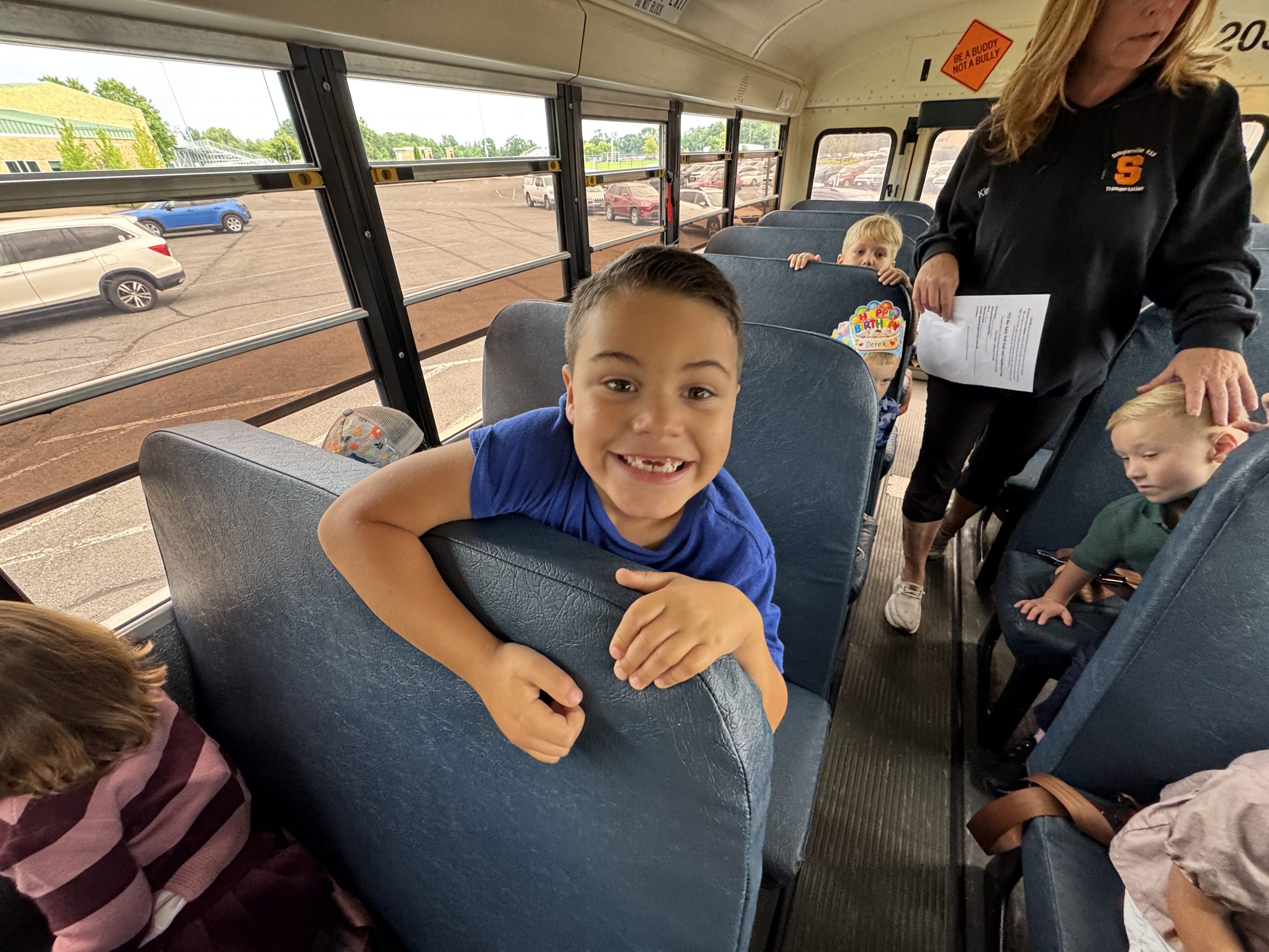 An elementary student participates in a school bus safety drill
